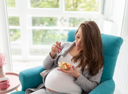 Pregnant woman eating salad