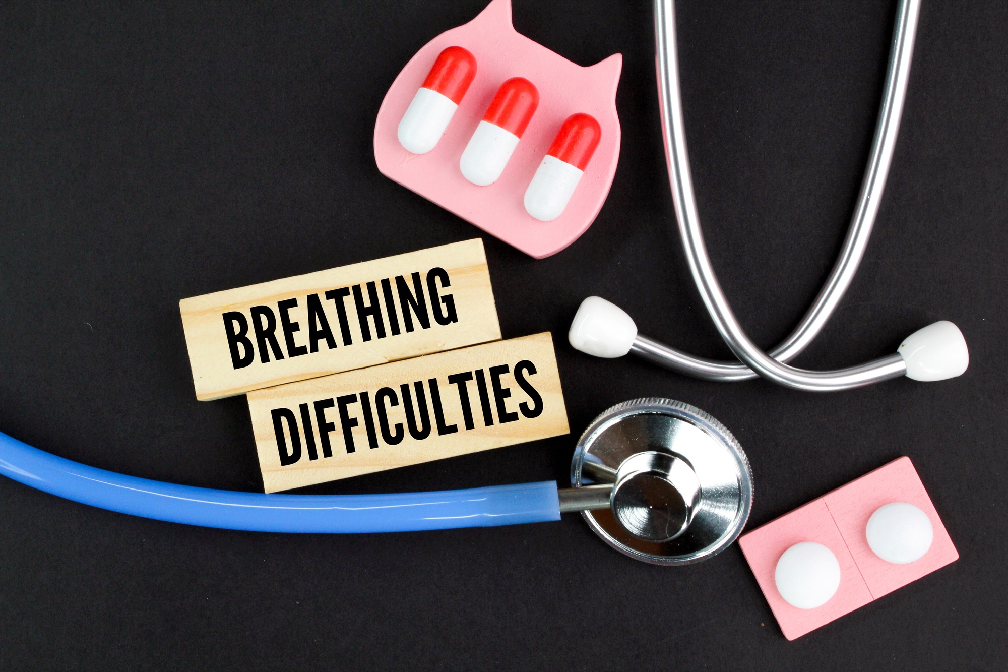 stethoscope and medicine with the word breathing difficulties