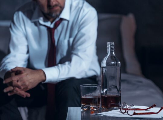 Tired man drinking alcohol