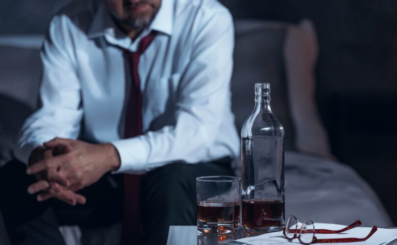 Tired man drinking alcohol